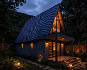 a small house with a pitched roof at night at Secret Garden Ella Cabana & Stay in Ella