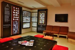 a waiting room with a table and chairs and a tv at Han Hotel Istanbul in Istanbul