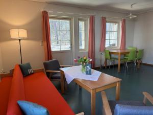 a living room with a couch and a table and chairs at martas Gästehäuser Groß Väter See in Templin
