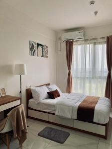 a bedroom with a large bed and a window at Sky House Hotel Style Bed IKEA 5min in Kampungklapa 2 +16 photos