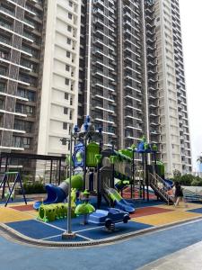 a playground in front of a large building at Sky House Hotel Style Bed IKEA 5min in Kampungklapa 2