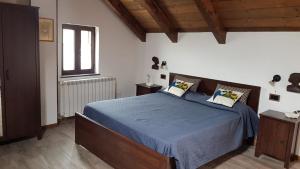 a bedroom with a bed with blue sheets and a window at La Cicogna in Agerola +58 photos