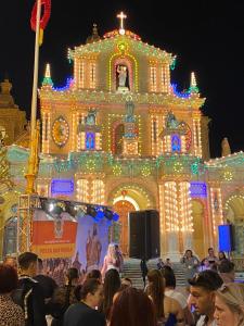 a group of people standing in front of a building with lights at Nina in Siġġiewi