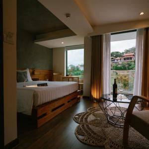 a bedroom with a large bed and a large window at Hanoi Amsterdam Art Studio in Da Lat