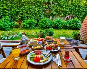 a wooden table topped with plates of food and drinks at Han Hotel Istanbul in Istanbul