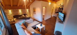 a living room with a couch and a flat screen tv at Haus Samurai in Saas-Grund