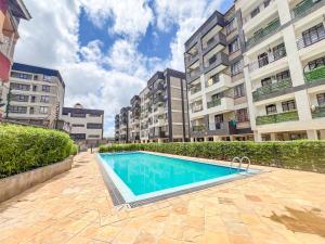 a swimming pool in front of some buildings at The Escape Muthiga Waiyaki way in Nairobi