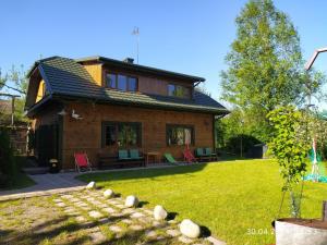 a house with a lawn in front of it at Siedlisko - Lipnik, cisza spokój wsród drzew in Nielisz