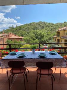 a table on a balcony with blue dishes on it at La Pareina in Porto Ercole