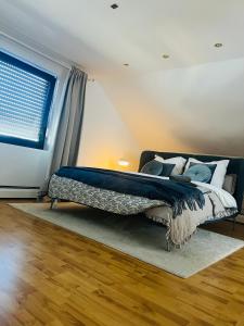 a bedroom with a bed with a blue comforter and a window at Ruhige Wohnung in Meschede in Meschede