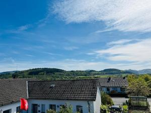 a view of roofs of houses with mountains in the background at Ruhige Wohnung in Meschede in Meschede