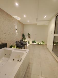 a large bathroom with a tub and chairs in it at Pyramids Glory Inn in Cairo +40 photos