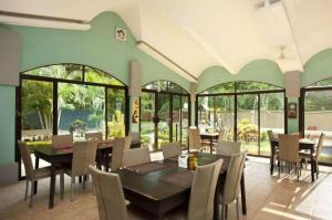 a dining room with a table and chairs at Pitaya Lodge in Potrero