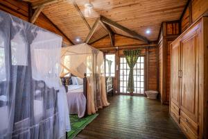 a bedroom with a bed in a room with wooden ceilings at Cliffside Amani Wooden Villa with Stunning Ocean Views for an Authentic Tanzanian Escape in Dar es Salaam +43 photos