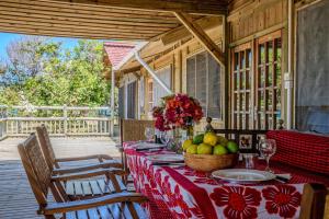 a table with a bowl of fruit on a porch at Cliffside Amani Wooden Villa with Stunning Ocean Views for an Authentic Tanzanian Escape in Dar es Salaam