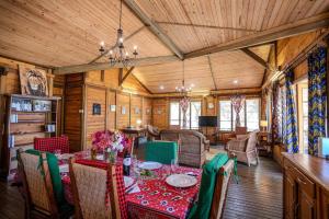 a dining room with a table and chairs at Cliffside Amani Wooden Villa with Stunning Ocean Views for an Authentic Tanzanian Escape in Dar es Salaam