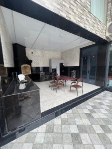a patio with a table and chairs in a building at Beshik Apartment 2 in Samarkand