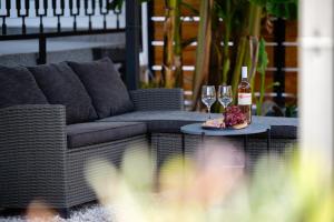 a couch and two glasses of wine on a table at Ante room's in Trogir