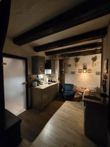 a kitchen with a table and a blue chair at Woodland Apartment Small in Berezka +44 photos