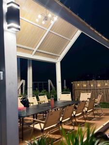 a patio with a black table and chairs at KlomKlom garden home in Ban Tha Kham