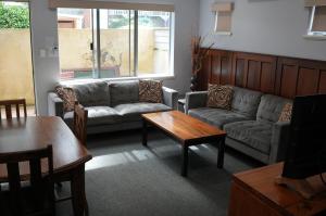 a living room with couches and a table at Adamsons Riverside in Margaret River Town