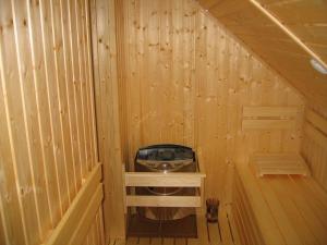 a inside of a wooden sauna with a stove at Apartmán Ria in Hriňová