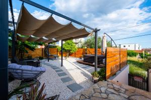a patio with awning and a fence at Ante room's in Trogir