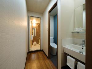 a bathroom with a sink and a toilet at Isahaya Daiichi Hotel in Isahaya +60 photos