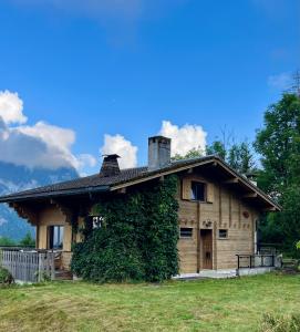 a house with ivy growing on the side of it at Chalet les Marmottes in Saint-Jean-de-Sixt