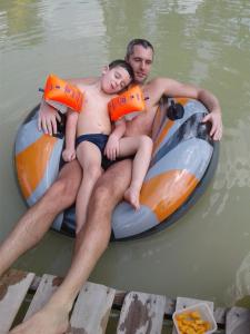 a man and a woman sitting on a raft in the water at Thambili Adventure Resort in Negombo