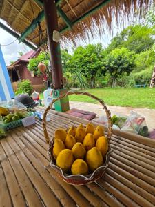 a basket of lemons sitting on a table at nam jai pai in Ban Wiang Nua
