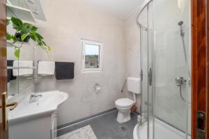a bathroom with a sink toilet and a shower at Apartmani Petracie in Drvenik +42 photos
