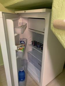 an empty refrigerator with its door open and food inside at B&B Verde Pastello in Pianopoli +12 photos