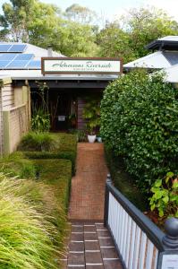 a brick walkway in front of a house with a sign at Adamsons Riverside in Margaret River Town