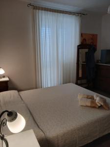 a bedroom with a bed with a towel on it at Casa venere in Pachino