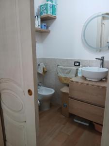 a bathroom with a sink and a toilet and a mirror at Casa venere in Pachino +19 photos