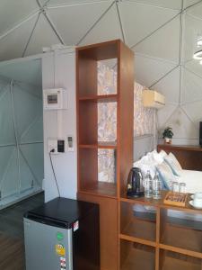 a room with a kitchen and a table and a room with a room at PaPa Q suite Resort in Roi Et