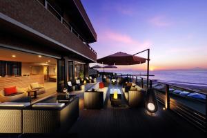 a restaurant with a view of the ocean at sunset at ゆうみ in Kyonan
