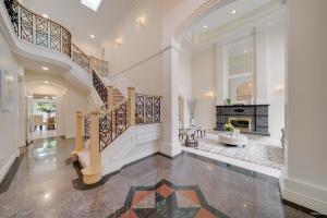 a large living room with stairs and a fireplace at Cozy home near YVR with free parking in Richmond