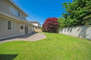 a backyard of a house with a fence at Cozy home near YVR with free parking in Richmond