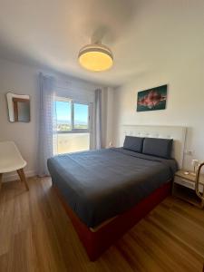 a bedroom with a large bed and a window at Fantastic Seaview Apartment in Alicante +59 photos
