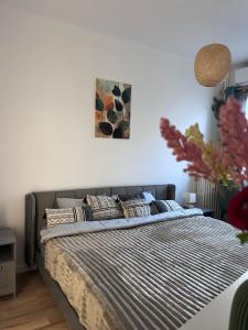 a bedroom with a bed with pillows on it at De Gaulle 2 pièces Сentral Appartement in Cagnes-sur-Mer