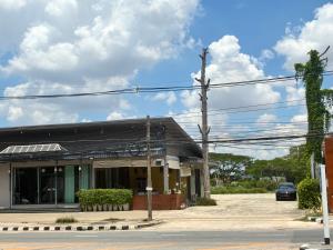a black building with a car parked in front of it at PaPa Q suite Resort in Roi Et +20 photos