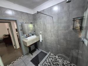 a bathroom with a sink and a mirror at Next to Heaven Guesthouse in Stormsrivier +25 photos