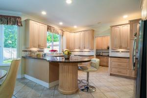 a large kitchen with a island in the middle at Cozy home near YVR with free parking in Richmond
