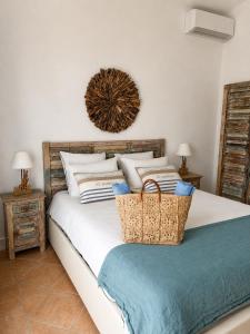 a bedroom with a bed with baskets on it at La Parenthèse de Villepey in Saint-Aygulf +37 photos
