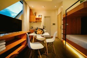 a room with a table and chairs and a bedroom at Hanoi Amsterdam Art Studio in Da Lat +84 photos
