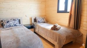 a bedroom with two beds with teddy bears on them at Tsovazard Lake House in Tsovazard