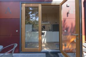 a kitchen with a sliding glass door in a house at HOTEL SPATZENNEST Vogelsberg in Herbstein +51 photos