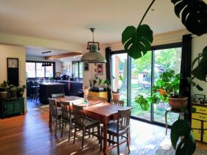 a kitchen and dining room with a table and chairs at Maison paisible en lisière de foret 9 personnes in Le Temple +16 photos